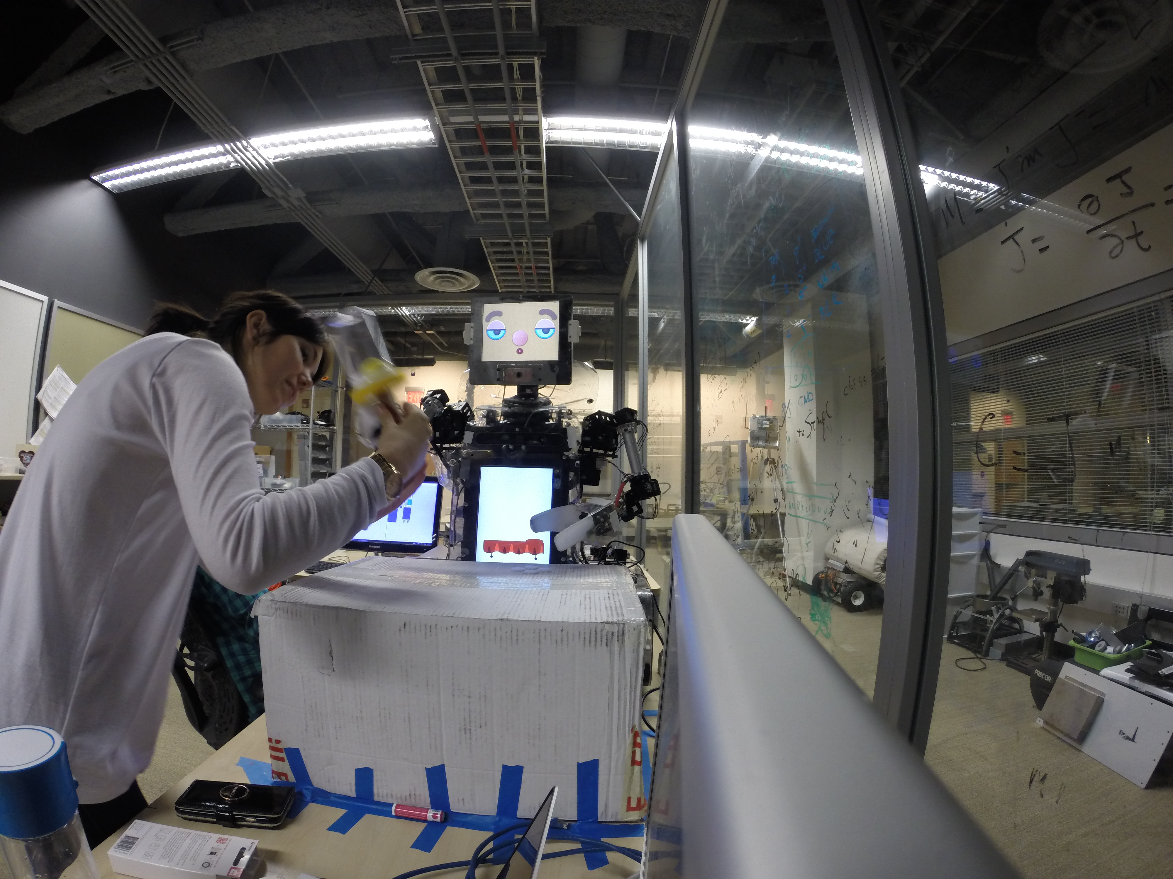 Kristyn programming RUBI, the social robot, in the lab.